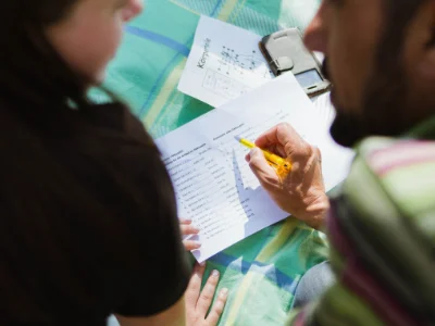 2 Studierende übersetzen Texte auf einem Blatt von Deutsch nach Englisch